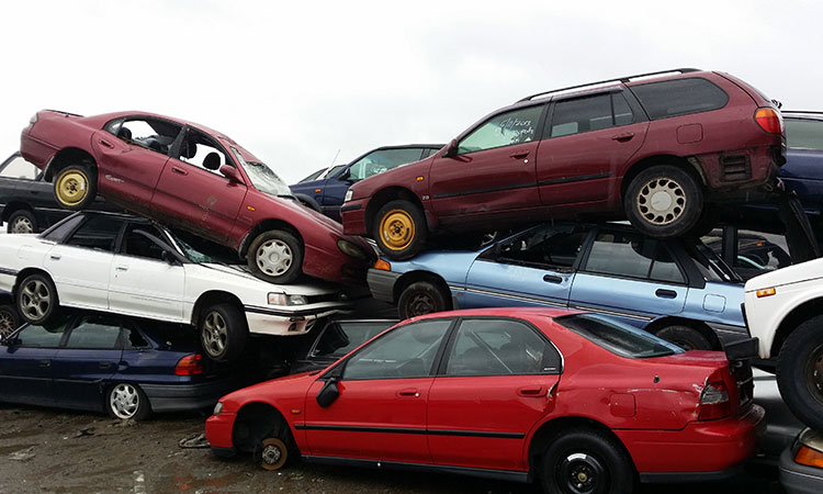stacked automotive scrap and unused car chassis